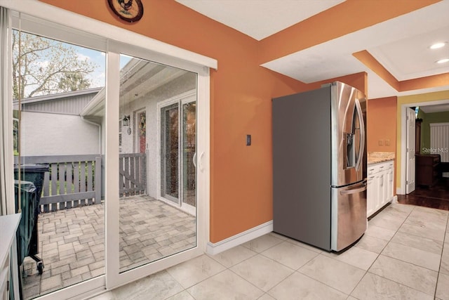 50 Balsam Dr, Oldsmar, FL 34677 - kitchen featuring stainless steel fridge with ice dispenser, light stone counters, white cabinetry, baseboards, and recessed lighting