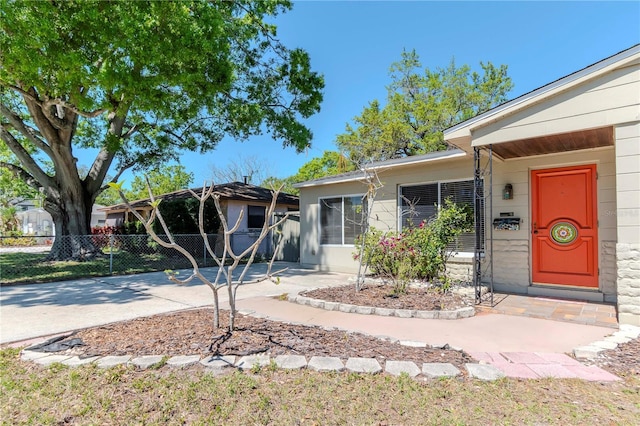 single story home featuring fence