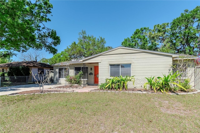 ranch-style house with fence and a front yard