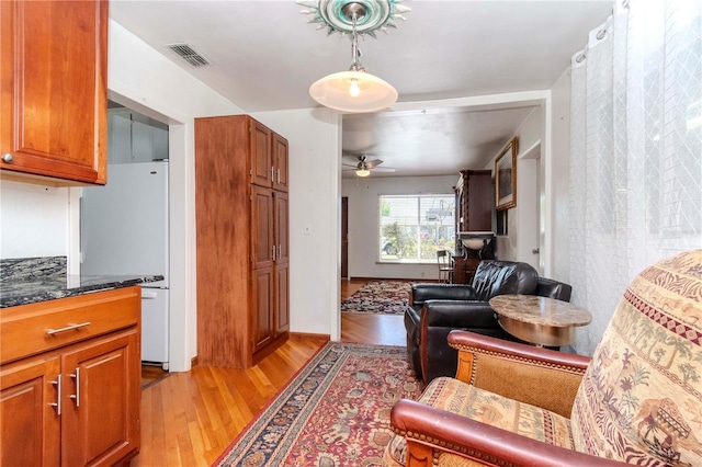 interior space with visible vents, ceiling fan, and light wood-style flooring