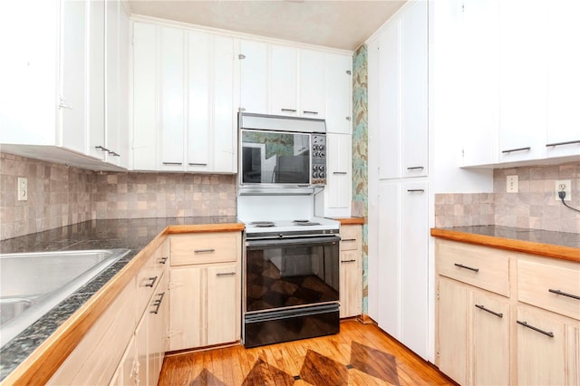 kitchen with white cabinets, a sink, light wood finished floors, range with electric stovetop, and backsplash