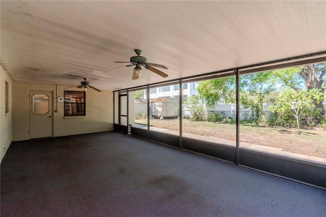 unfurnished sunroom featuring ceiling fan