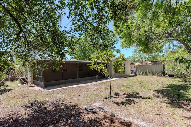 back of house with a sunroom and fence