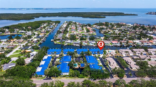 drone / aerial view with a water view and a residential view