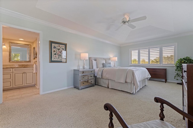 bedroom featuring a sink, light colored carpet, a tray ceiling, baseboards, and ornamental molding