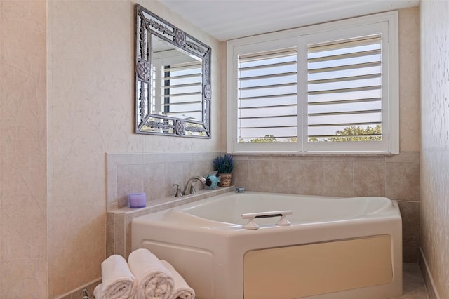 full bathroom featuring a garden tub and plenty of natural light