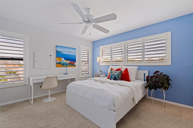 bedroom featuring carpet flooring, multiple windows, and baseboards