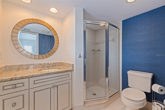 bathroom featuring recessed lighting, tile patterned flooring, a shower stall, toilet, and vanity