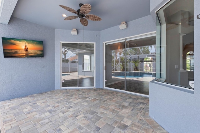 exterior space with ceiling fan