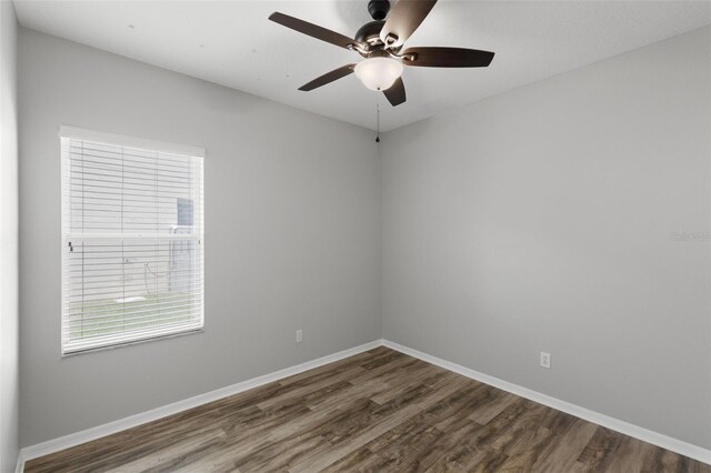 empty room featuring wood finished floors, ceiling fan, plenty of natural light, and baseboards