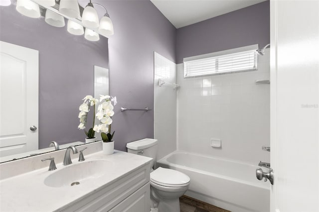 full bath featuring wood finished floors, vanity, toilet, and  shower combination