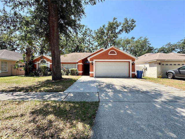 ranch-style home featuring a front lawn, driveway, a garage, and stucco siding