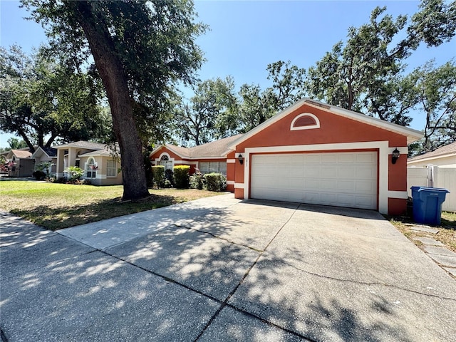 single story home featuring stucco siding, concrete driveway, and a garage