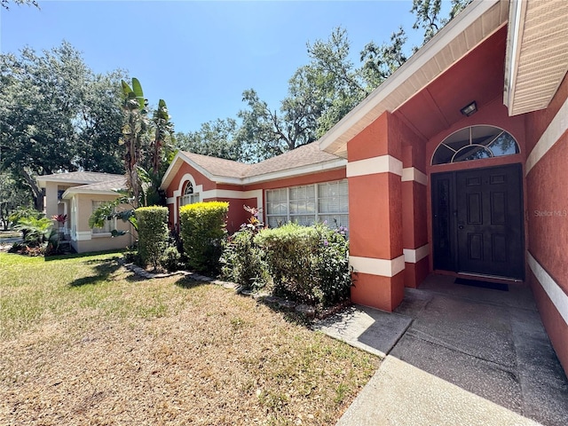 property entrance with a yard