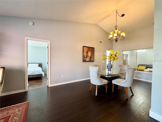 dining room featuring a notable chandelier, visible vents, baseboards, a textured ceiling, and wood finished floors
