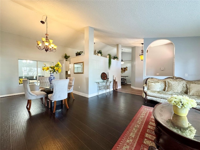 interior space featuring a chandelier, baseboards, a textured ceiling, and wood-type flooring