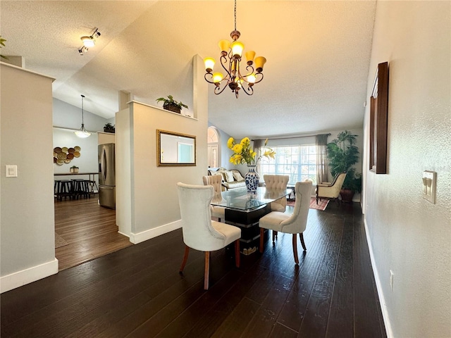 dining space with an inviting chandelier, wood finished floors, vaulted ceiling, and baseboards