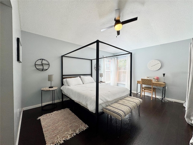 bedroom featuring a textured ceiling, a ceiling fan, wood finished floors, and baseboards