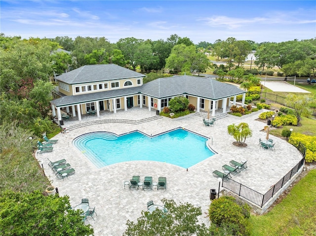 pool featuring fence and a patio area