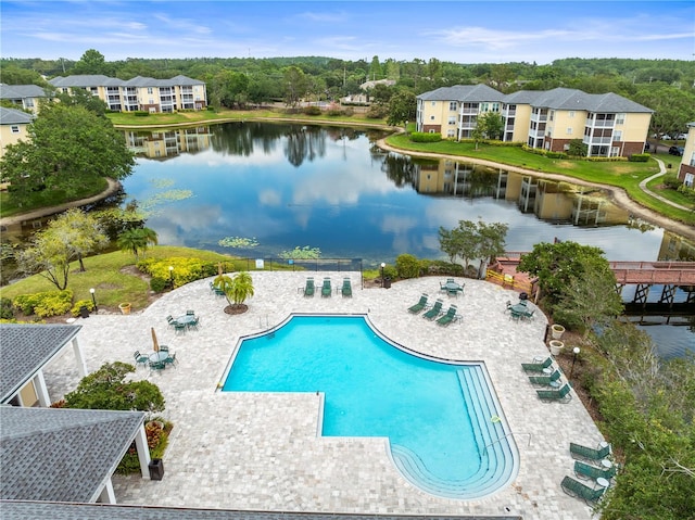 community pool featuring a water view and a patio
