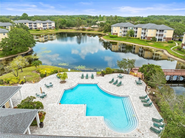 pool with a water view and a patio area