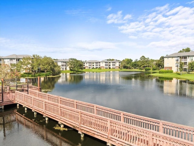 dock area featuring a water view and a residential view