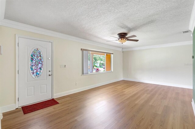 3065 Merrill Ave, Clearwater, FL 33759 - entrance foyer featuring light wood finished floors, a textured ceiling, ceiling fan, ornamental molding, and baseboards