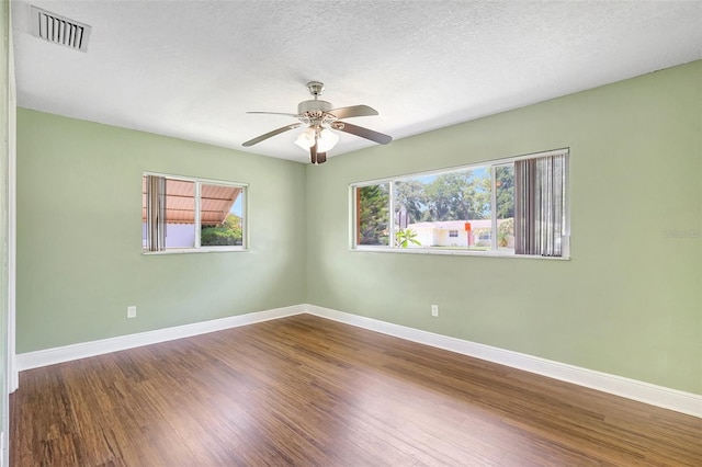 3065 Merrill Ave, Clearwater, FL 33759 - spare room with baseboards, ceiling fan, wood finished floors, and a textured ceiling
