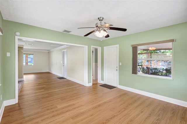 3065 Merrill Ave, Clearwater, FL 33759 - spare room featuring light wood finished floors, baseboards, ceiling fan, and ornamental molding