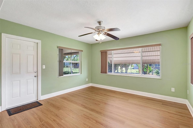 3065 Merrill Ave, Clearwater, FL 33759 - entryway featuring light wood-style flooring, ceiling fan, baseboards, and a textured ceiling