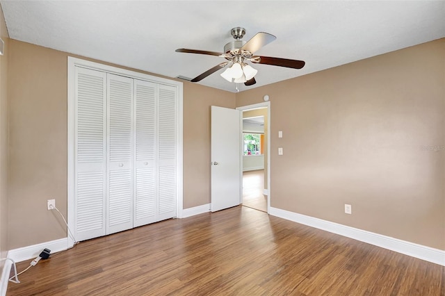 3065 Merrill Ave, Clearwater, FL 33759 - unfurnished bedroom featuring wood finished floors, baseboards, a closet, and ceiling fan