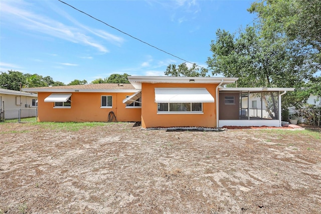 3065 Merrill Ave, Clearwater, FL 33759 - rear view of property with a sunroom and stucco siding