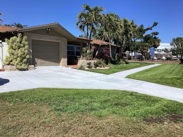 101 Madonna Blvd, Saint Petersburg, FL 33715 - single story home featuring a garage, driveway, a front yard, and stucco siding
