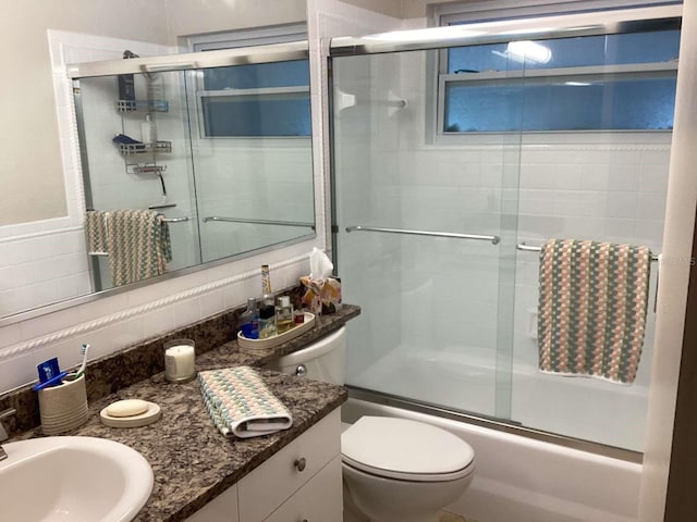 101 Madonna Blvd, Saint Petersburg, FL 33715 - bathroom with shower / bath combination with glass door, tasteful backsplash, toilet, and vanity