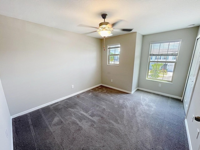 4456 Globe Thistle Dr, Tampa, FL 33619 - spare room with dark carpet, a ceiling fan, and a smoke detector