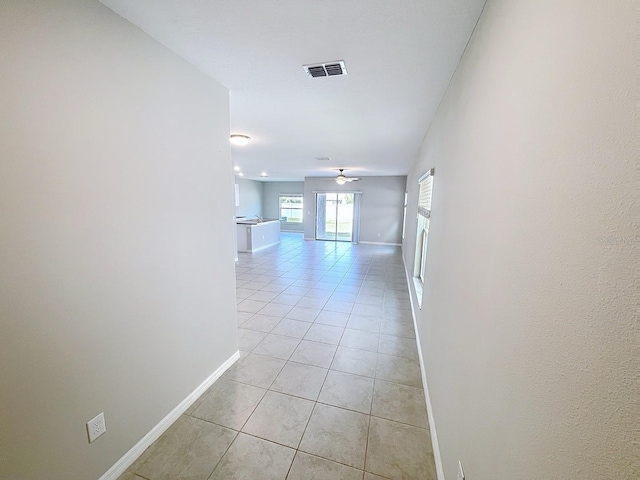 4456 Globe Thistle Dr, Tampa, FL 33619 - hall with baseboards and light tile patterned floors