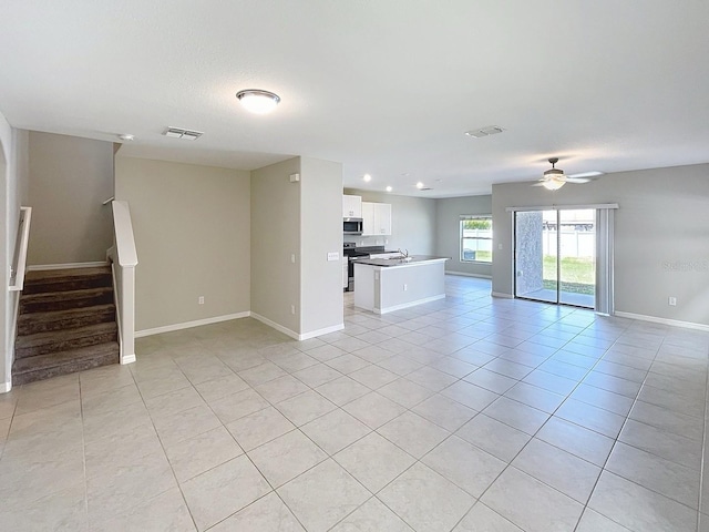 4456 Globe Thistle Dr, Tampa, FL 33619 - unfurnished living room with a ceiling fan, light tile patterned floors, stairs, and recessed lighting