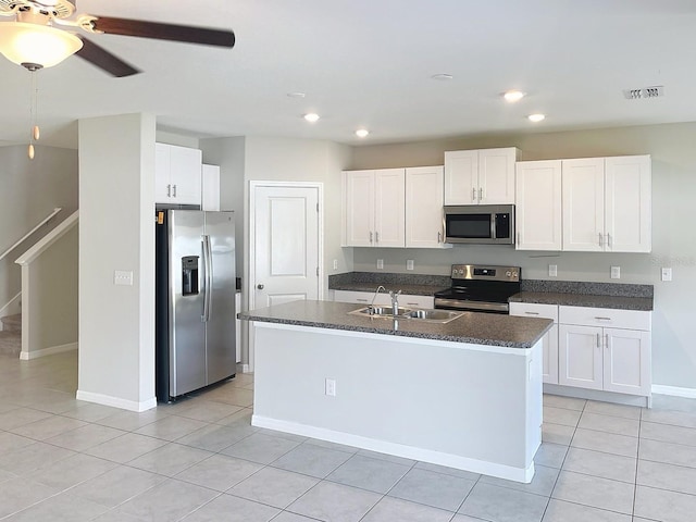 4456 Globe Thistle Dr, Tampa, FL 33619 - kitchen featuring stainless steel appliances, white cabinetry, recessed lighting, a kitchen island with sink, and light tile patterned flooring