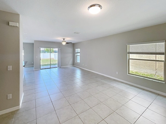 4456 Globe Thistle Dr, Tampa, FL 33619 - unfurnished room featuring ceiling fan, light tile patterned floors, and a textured ceiling