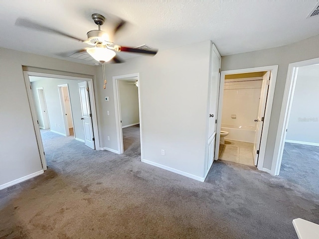 4456 Globe Thistle Dr, Tampa, FL 33619 - unfurnished bedroom featuring carpet, connected bathroom, and a ceiling fan