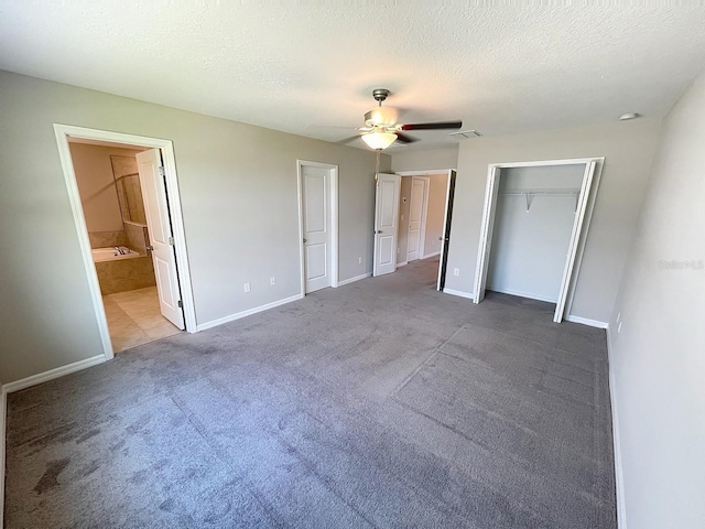 4456 Globe Thistle Dr, Tampa, FL 33619 - unfurnished bedroom with carpet flooring, ceiling fan, a textured ceiling, connected bathroom, and a closet