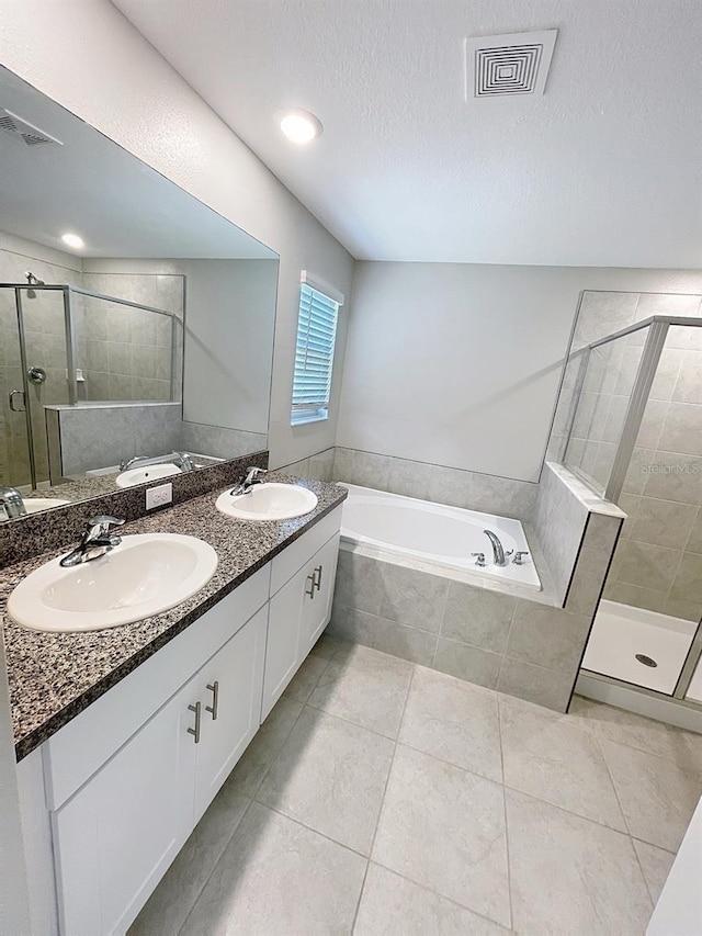 4456 Globe Thistle Dr, Tampa, FL 33619 - full bath with a garden tub, a stall shower, double vanity, tile patterned floors, and a textured ceiling