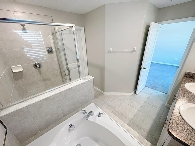 4456 Globe Thistle Dr, Tampa, FL 33619 - full bath with a shower stall, a garden tub, double vanity, and tile patterned flooring