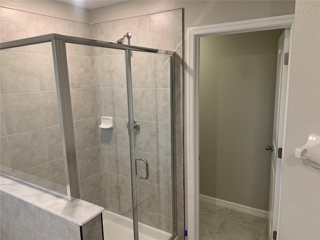 4456 Globe Thistle Dr, Tampa, FL 33619 - bathroom with a stall shower and tile patterned flooring