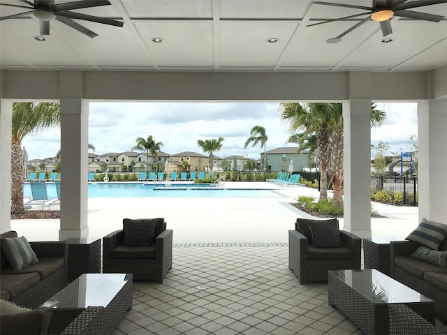 4456 Globe Thistle Dr, Tampa, FL 33619 - community pool with ceiling fan, a residential view, and outdoor lounge area