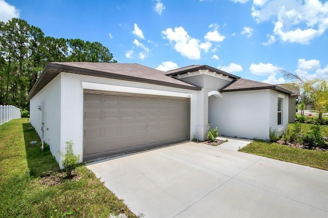 13419 Willow Bluestar Loop, Riverview, FL 33579 - view of front of home with a garage, stucco siding, driveway, and fence