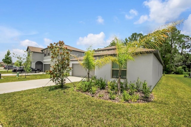 13419 Willow Bluestar Loop, Riverview, FL 33579 - view of side of home with concrete driveway, an attached garage, a yard, and stucco siding