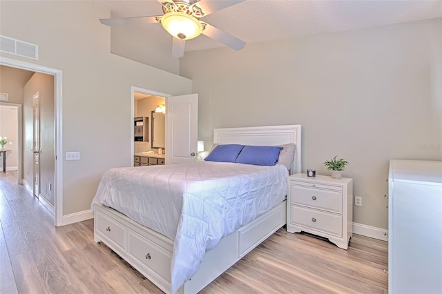 bedroom featuring baseboards, visible vents, ensuite bath, and light wood-style flooring