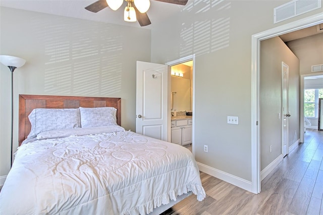 bedroom with baseboards, visible vents, a ceiling fan, and light wood-style floors