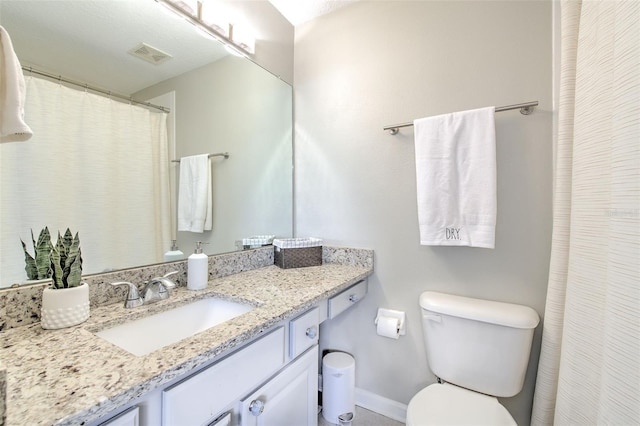 bathroom featuring visible vents, toilet, vanity, and baseboards